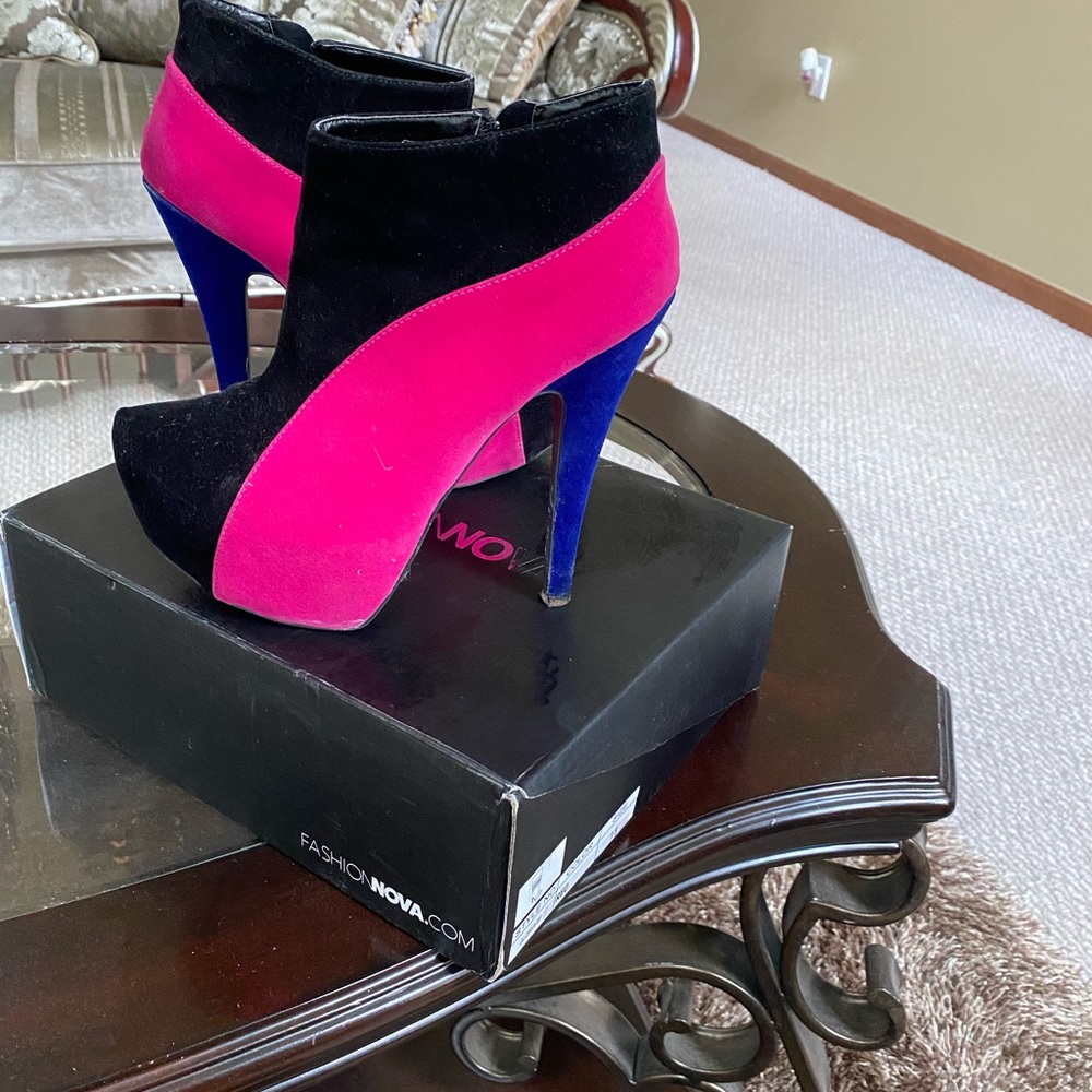 Woman’s pink black and blue heels